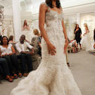 This unforgettable couture design has beaded straps that match the motif of the bodice.