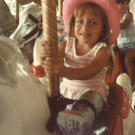 Jen taking a spin on the merry go round.