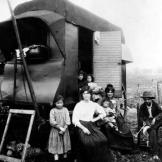 In this photo taken around 1900, gypsies in Paris pose by their caravan.