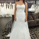 This A-line gown with lace-embroidered overlay and sweetheart neckline is well-suited for spring and summer weddings.