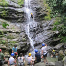 The Roloffs take turns rapelling down the waterfall.