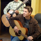 Zach and Lawson Bates playing guitar.