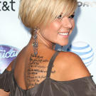 Another American Idol star, Kimberly Caldwell (the seventh place contestant in season two) came to LA Ink to see Kat Von D. She received the words to her own song "With You I Can" tattooed on her back.