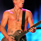 Lead guitarist in Def Leppard visits LA Ink with his fiance to get each other's name on their abdomens.
