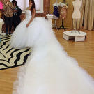 Amber shows off her spectacularly long train in Sondra's shop.