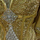 The bodice of Kayla's dress is covered in gold Swarovski crystals that Sondra special-ordered from Austria.