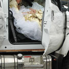 It wasn't easy, but Kayla stuffs herself into the passenger's seat of a monster truck wearing her wedding dress.