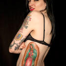 Tim tattoos Amy with a Lady of Guadalupe on her ribs.