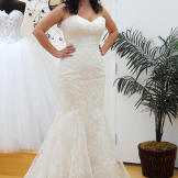 Bright white lace and a sweetheart neckline play up this bride's curves.