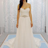 This white strapless wedding gown reads 'Greek goddess' with its artful folds and airy fabric.