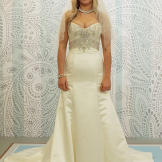 Beads that wrap the waist and frame the bust can minimize a bride's stomach and chest.