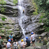 The Roloffs take turns rapelling down the waterfall.