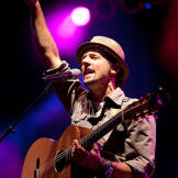 Musician Jason Mraz writes upbeat tunes. He and his friends want Kat to tattoo them with the words, "Be Love," plus a circle and a triangle on his arm.