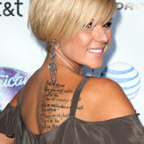 Another American Idol star, Kimberly Caldwell (the seventh place contestant in season two) came to LA Ink to see Kat Von D. She received the words to her own song "With You I Can" tattooed on her back.