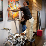 Billy DeCola hanging shop art.