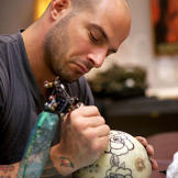 Billy DeCola practicing tattooing.