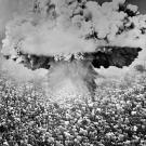 This 1961 photomontage shows an atomic mushroom cloud rising in the middle of a crowd of helpless people.