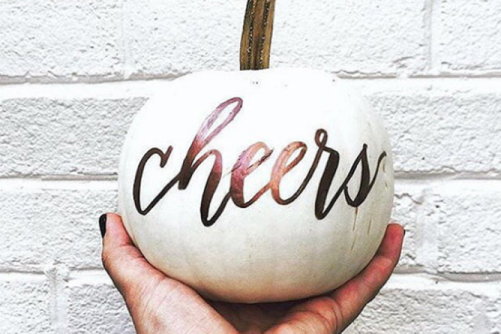 White pumpkin with cheers written on it