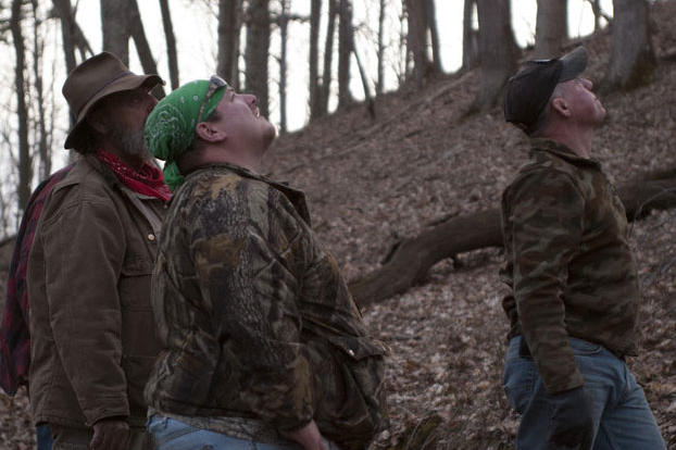 Trapper (left), Buck (center) and Wild Bill watch as Willy climbs a tree.