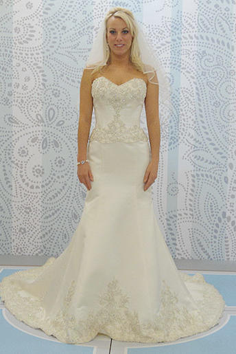 A chic trumpet silhouette makes the bride look even longer and leaner with beadwork on the bodice.