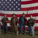 Team AIMS (Appalachian Investigators of Mysterious Sightings) poses in front of an American flag.