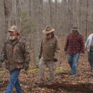 The team walks through the Appalachian forest.