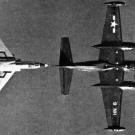 A Vought F7U-3 Cutlass of experimental squadron VX-3 gets in as close as it can to refuel from an AJ-2 Savage .