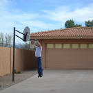 Ed Rosenberg dunks a basketball in front of his newly acquired property.