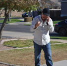 John Ray celebrates after successfully purchasing a property at auction.