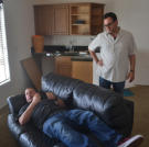 Scott Menaged lounges while Lou Amoroso looks on at a recently acquired property.