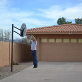 Ed Rosenberg dunks a basketball in front of his newly acquired property.