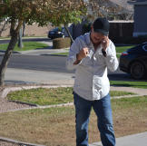 John Ray celebrates after successfully purchasing a property at auction.