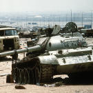 A destroyed Iraqi T-55 main battle tank lies amidst other destroyed vehicles along the highway between Kuwait City and Basra, Iraq, following the retreat of Iraqi forces from Kuwait during Operation Desert Storm.
Watch