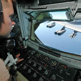 A boom operator of a KC-135 Stratotanker during an aerial refueling of a B-52 Stratofortress in Afghanistan, March 2006.