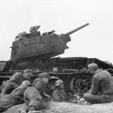 Soldiers of the 3rd SS-Panzer-Division Totenkopf (skull) resting next to a destroyed Soviet tank T-34. Even disabled it can provide cover.
Watch