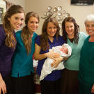 The birthing team beams with Baby Marcus.