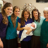 The birthing team beams with Baby Marcus.