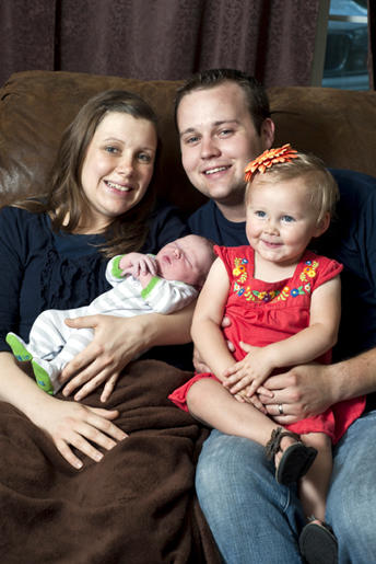 Josh and Anna Duggar with their daughter Mackynzie and their new son.
