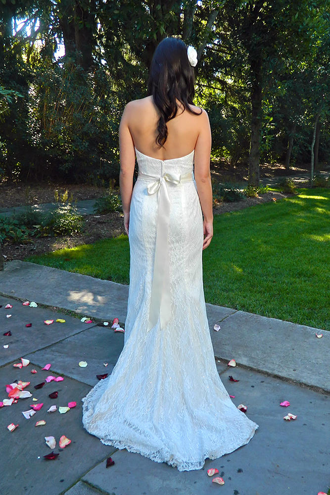 Jenny in her wedding dress from behind.