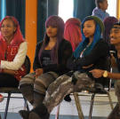 The OMG Girlz and choreographer Sean Bankhead watch as the kids perform.