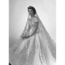 Jackie Kennedy poses for her bridal portrait in her Anne Lowe wedding dress at Bachrach's New York studio in 1953.