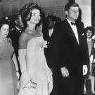 On June 30, 1962, the president and first lady attend a reception in Mexico City. Jackie wears a gown by designer Oleg Cassini.