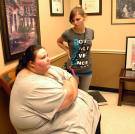 Christina is 22 years old and weighs 673 pounds. "I never thought I'd get this big," she explains, but at her size, she can't drive and isn't motivated to leave her house. Here, she waits for a consultation with weight-loss surgeon Dr. Nowzaradan.