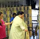 Aided by a walker and cheered on by her mother, Christina gets some exercise at the hospital.