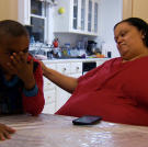Tara and her son share a moment together at the kitchen table.