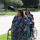 Olivia's sister-in-law follows behind with a wheelchair in case Olivia needs to rest.