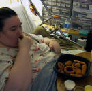 Penny eats a meal in her bed. All of her meals are served by Ed, and he does the grocery shopping from lists that Penny prepares.