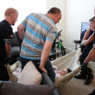 Penny is lifted into bed at her temporary apartment in Texas.