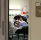 Penny rests in a recovery room after surgery.