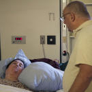 Penny's husband visits her after her surgery.